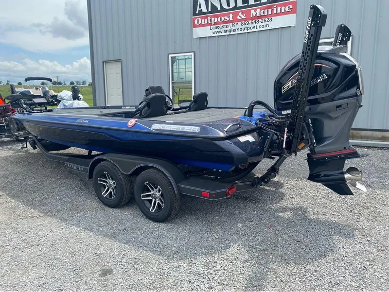 Slide: The Image of 2025 Skeeter ZXR 21 boat with Yamaha engine, parked on gravel near Angler's Outpost & Marine. - 6