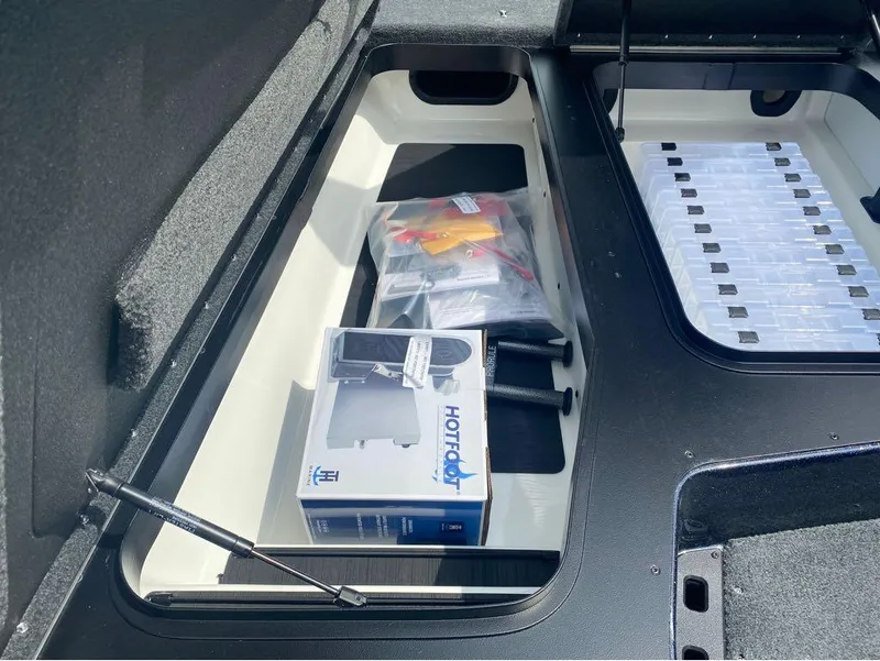 Slide: The Image of Storage compartment in a 2025 Skeeter ZXR 21 boat with organized gear and accessories. - 7