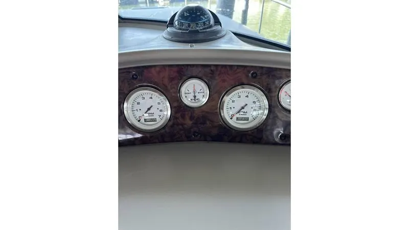 Slide: The Image of Dashboard of 2002 Sea Ray 340 Sundancer with gauges and compass. - 14