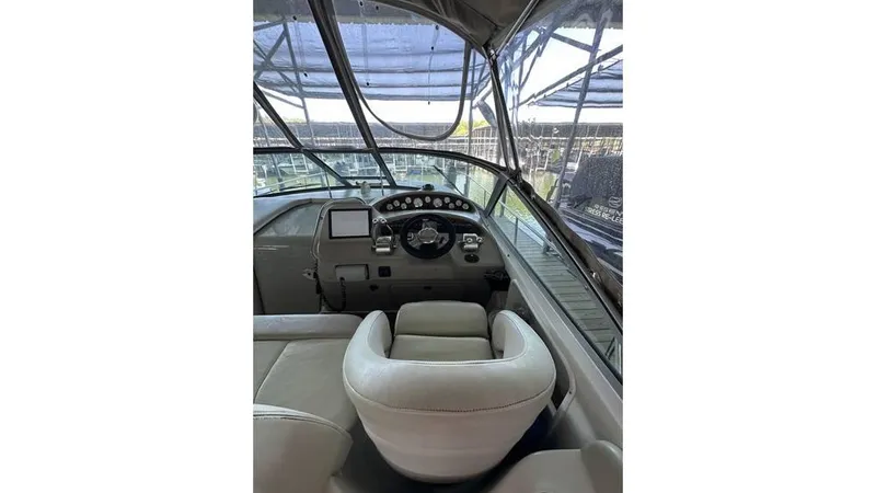 Slide: The Image of 2002 Sea Ray 340 Sundancer helm with steering wheel and dashboard controls. - 15