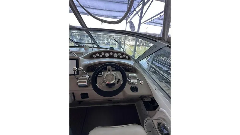Slide: The Image of Helm of 2002 Sea Ray 340 Sundancer with steering wheel and control panel. - 16