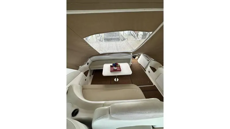 Slide: The Image of 2002 Sea Ray 340 Sundancer interior with seating and table under canopy. - 17