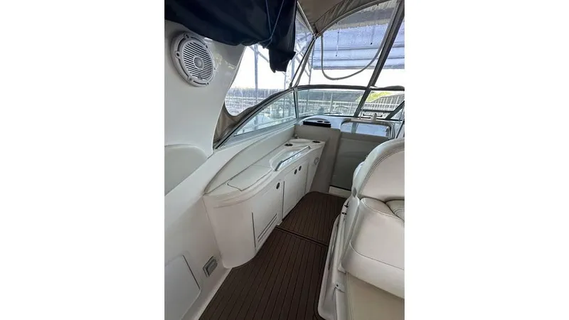 Slide: The Image of 2002 Sea Ray 340 Sundancer interior with seating and control panel. - 19