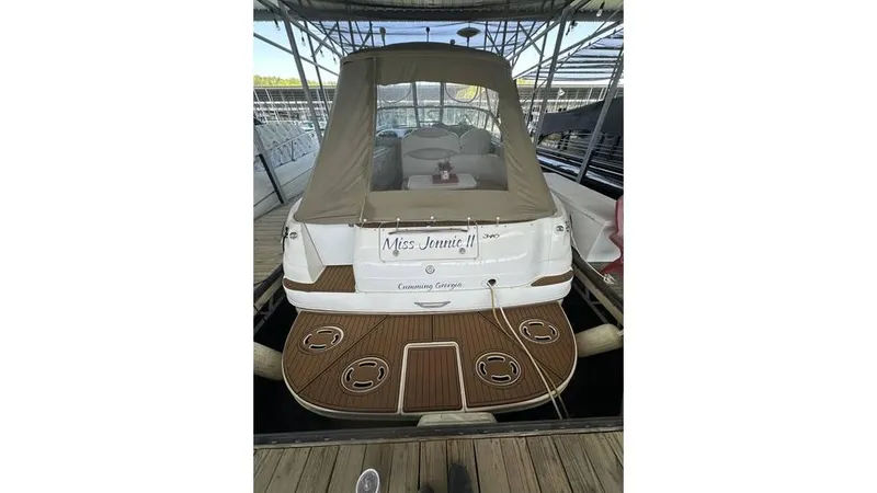 Slide: The Image of 2002 Sea Ray 340 Sundancer docked, rear view with covered seating area. - 21