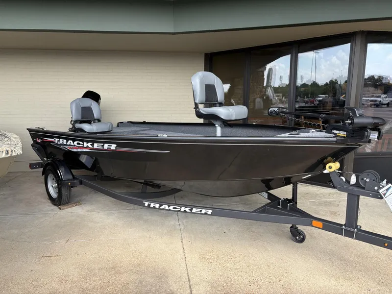 The Image of 2025 Tracker Super Guide V-16 T fishing boat on trailer, displayed outdoors. - 0