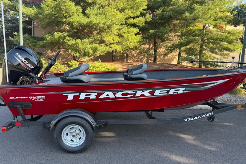 Slide: The Image of 2025 Tracker Super Guide V-16 T boat on trailer, red with Mercury engine. - 6