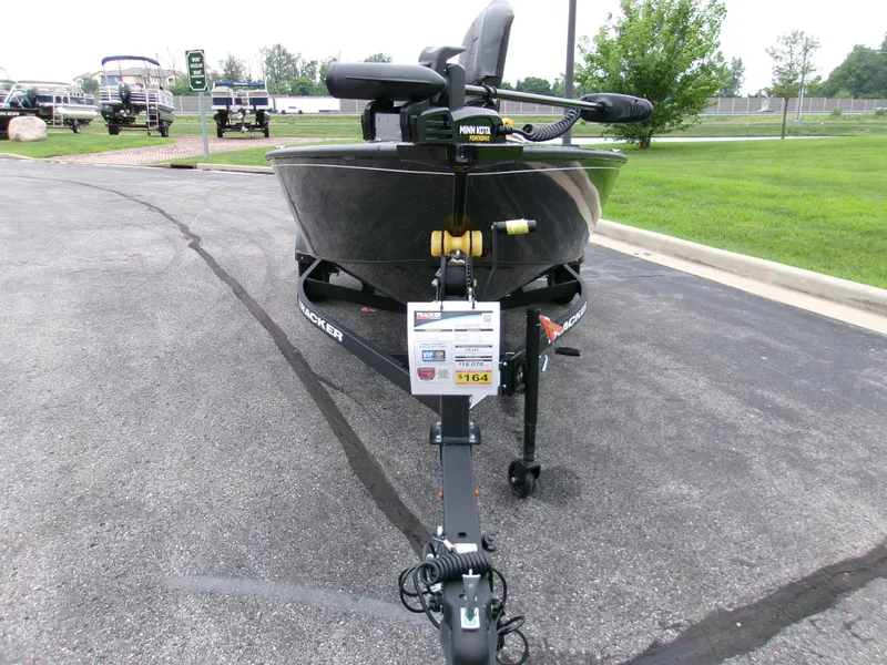 Slide: The Image of 2025 Tracker Super Guide V-16 T boat on trailer in parking lot. - 2