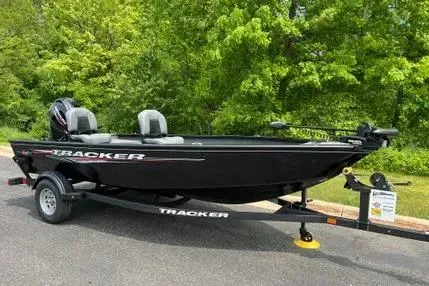 Slide: The Image of 2025 Tracker Super Guide V-16 T boat on trailer, parked outdoors. - 3
