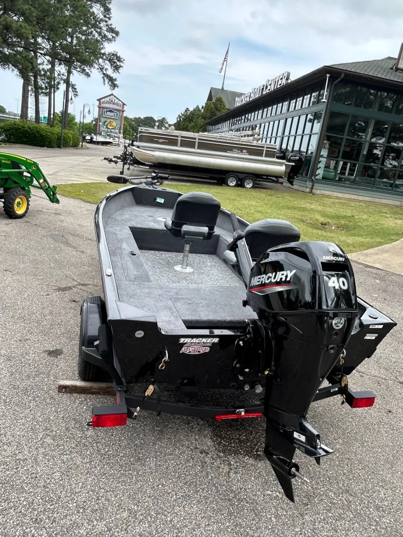 Slide: The Image of 2025 Tracker Super Guide V-16 T boat with Mercury 40 engine, parked outdoors. - 29