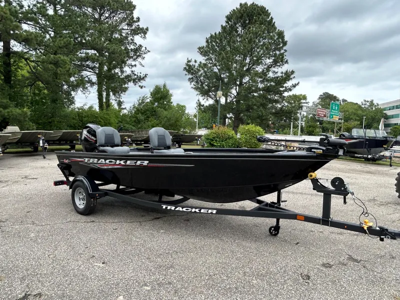 Slide: The Image of 2025 Tracker Super Guide V-16 T boat on trailer in outdoor setting. - 30
