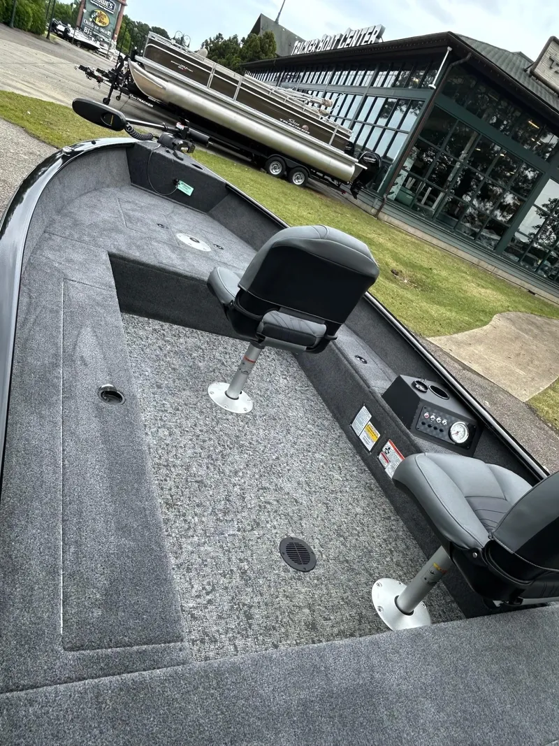 Slide: The Image of 2025 Tracker Super Guide V-16 T boat interior with seating and control panel. - 31