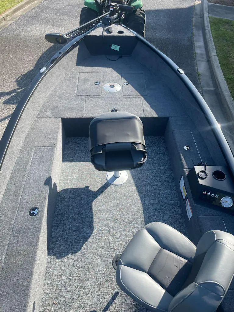 Slide: The Image of 2025 Tracker Super Guide V-16 T boat interior with seating and control panel. - 2