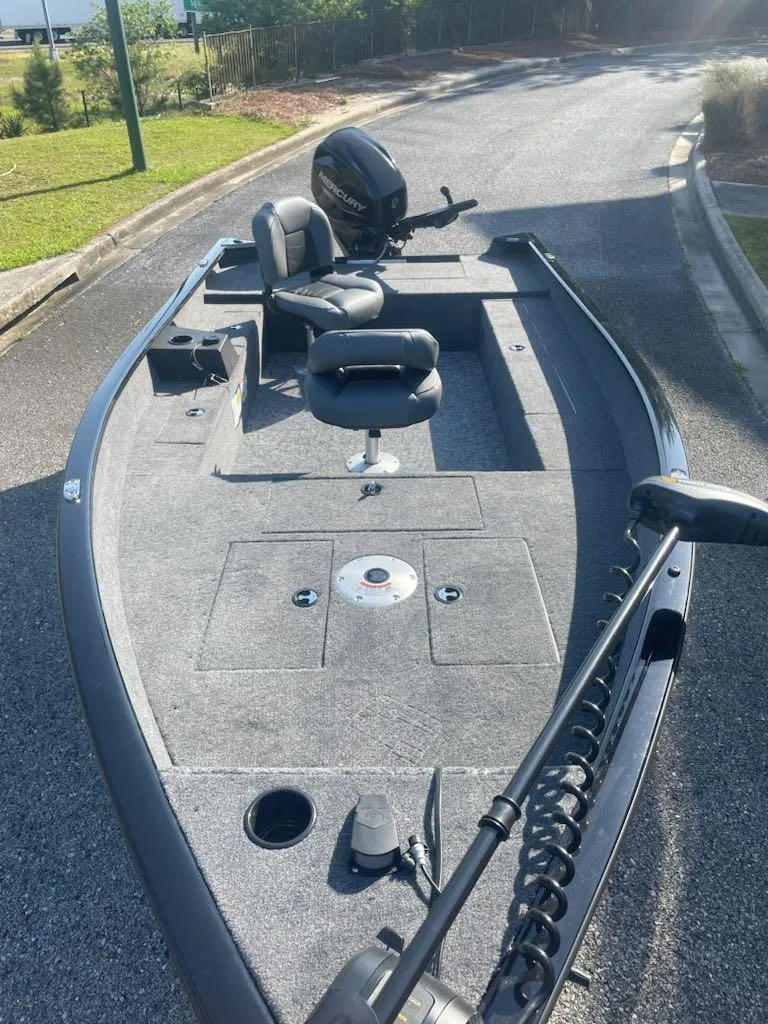 Slide: The Image of 2025 Tracker Super Guide V-16 T fishing boat with motor, seats, and storage compartments. - 3