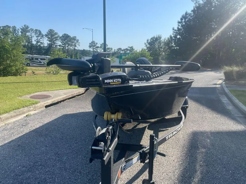 Slide: The Image of 2025 Tracker Super Guide V-16 T boat with Minn Kota trolling motor on a sunny day. - 4