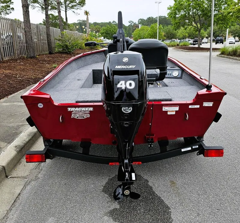 Slide: The Image of 2025 Tracker Super Guide V-16 T boat with Mercury 40 engine, parked on pavement. - 3