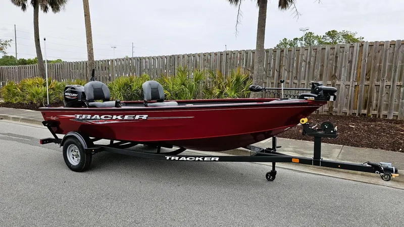 Slide: The Image of 2025 Tracker Super Guide V-16 T boat on trailer, parked on street. - 4