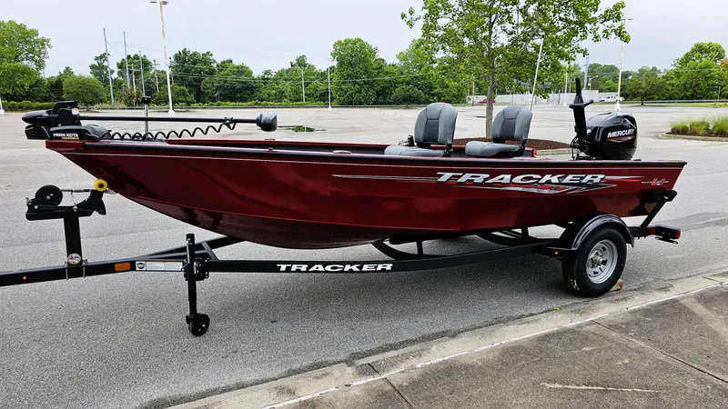 Slide: The Image of 2025 Tracker Super Guide V-16 T boat on trailer, parked outdoors. - 6