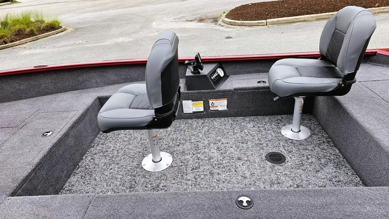 Slide: The Image of 2025 Tracker Super Guide V-16 T boat interior with two gray seats on a textured floor. - 9