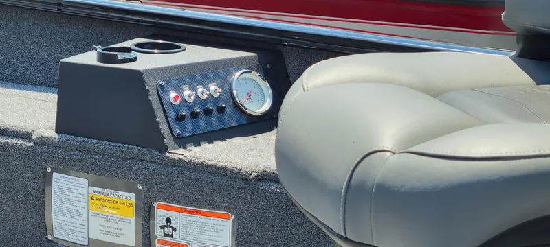 Slide: The Image of 2025 Tracker Super Guide V-16 T boat interior with control panel and seating. - 2