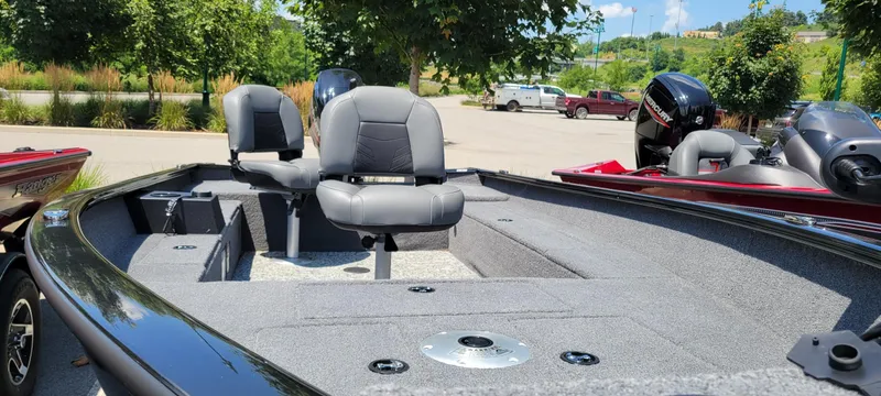 Slide: The Image of 2025 Tracker Super Guide V-16 T boat with seating, parked outdoors. - 3