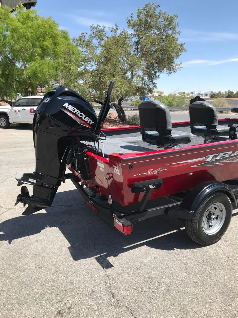 Slide: The Image of 2025 Tracker Super Guide V-16 T boat with Mercury engine, parked outdoors. - 4