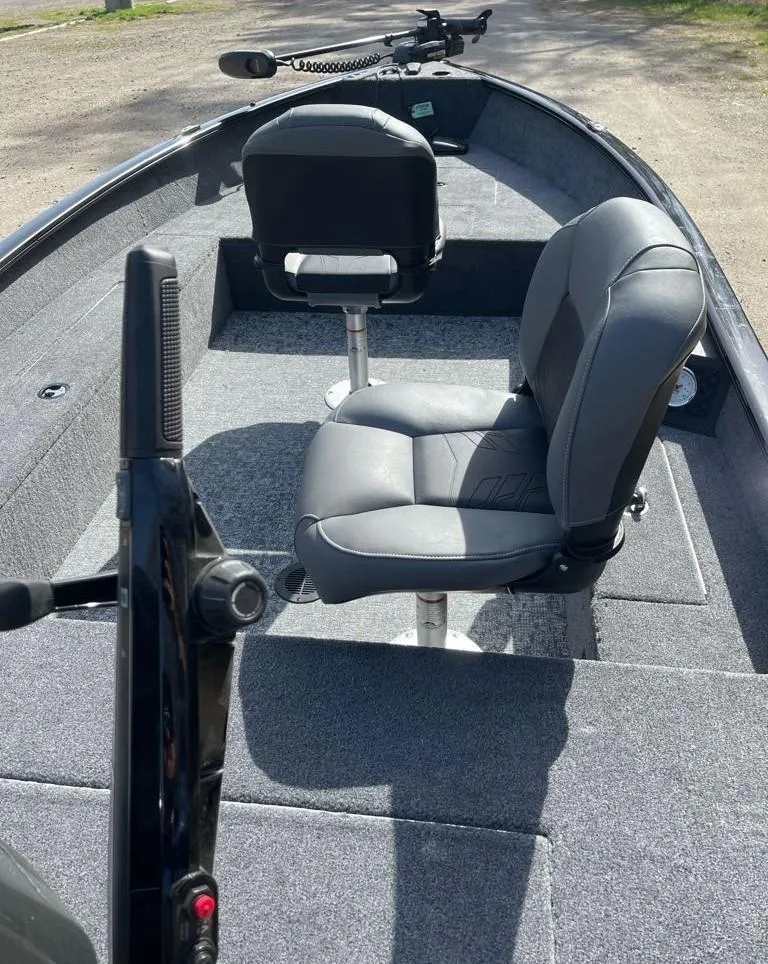 Slide: The Image of 2025 Tracker Super Guide V-16 T boat interior with two gray seats and carpeted flooring. - 4