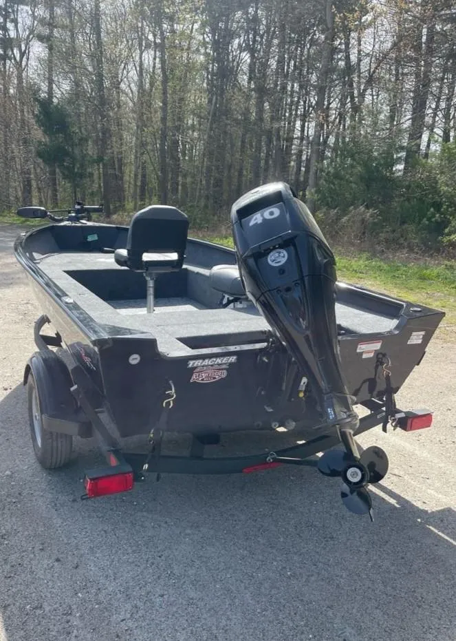 Slide: The Image of 2025 Tracker Super Guide V-16 T boat with 40 HP motor, parked outdoors. - 6