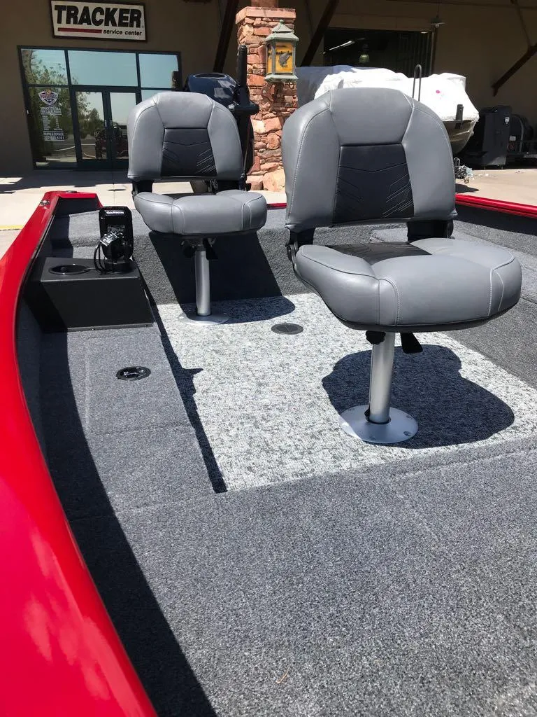 Slide: The Image of 2025 Tracker Super Guide V-16 T boat interior with two gray seats and red trim. - 5