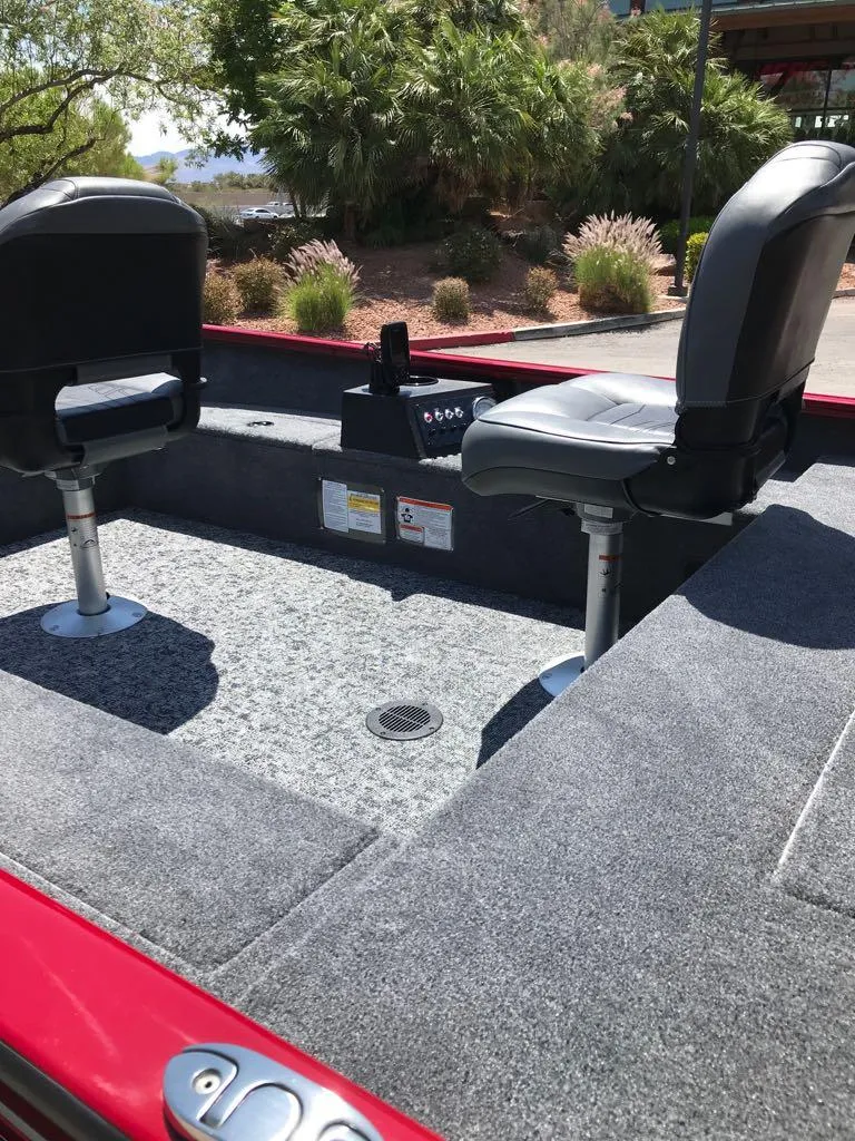 Slide: The Image of 2025 Tracker Super Guide V-16 T boat interior with two swivel seats and carpeted deck. - 6