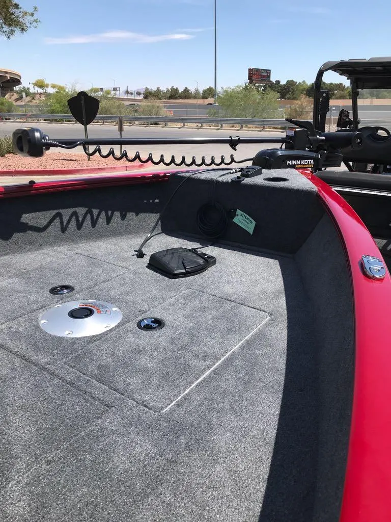 Slide: The Image of 2025 Tracker Super Guide V-16 T boat interior with red trim and Minn Kota trolling motor. - 7