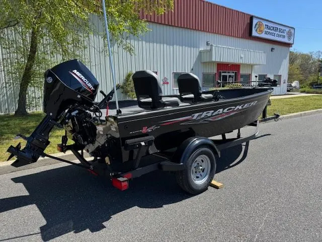 Slide: The Image of 2025 Tracker Super Guide V-16 T boat on trailer outside service center. - 2