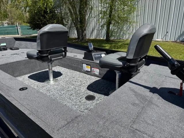 Slide: The Image of 2025 Tracker Super Guide V-16 T boat interior with two seats and control panel. - 5