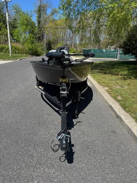 Slide: The Image of 2025 Tracker Super Guide V-16 T boat on trailer, parked on a sunny road. - 8