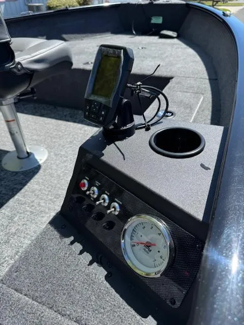 Slide: The Image of 2025 Tracker Super Guide V-16 T boat interior with control panel and fish finder. - 9