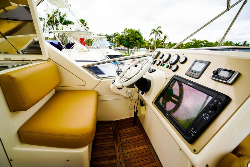 Slide: The Image of Luxurious seating area on 2012 Azimut Fly 53 yacht with wooden table and cushioned benches. - 11