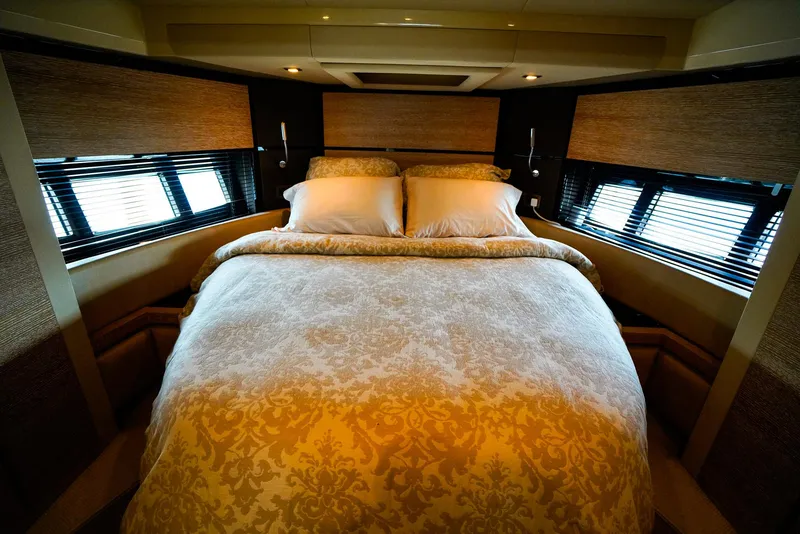 Slide: The Image of Luxurious bedroom interior on a 2012 Azimut Fly 53 yacht, featuring elegant bedding and ambient lighting. - 36