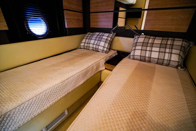 Slide: The Image of Interior cabin of 2012 Azimut Fly 53 yacht with twin beds and plaid pillows. - 40