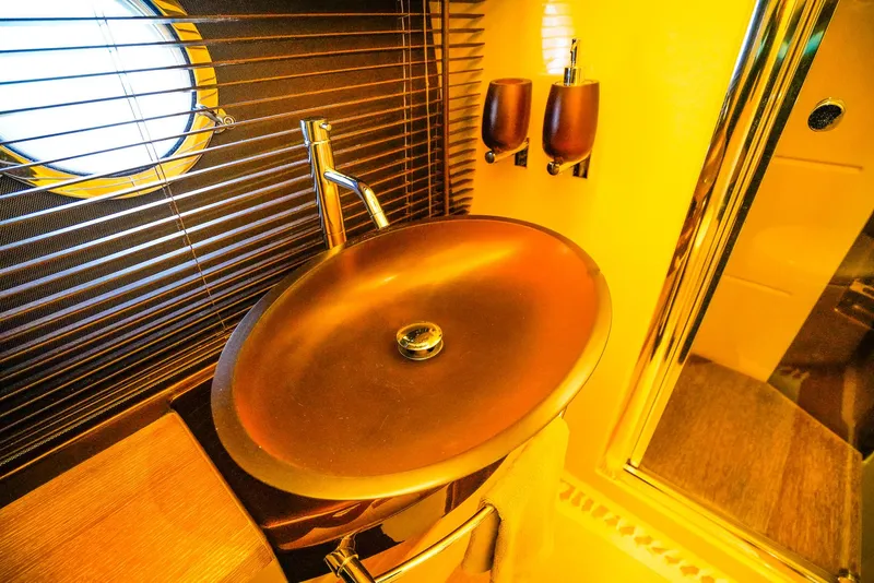 Slide: The Image of Luxurious bathroom sink in 2012 Azimut Fly 53 yacht, featuring modern design and warm lighting. - 46