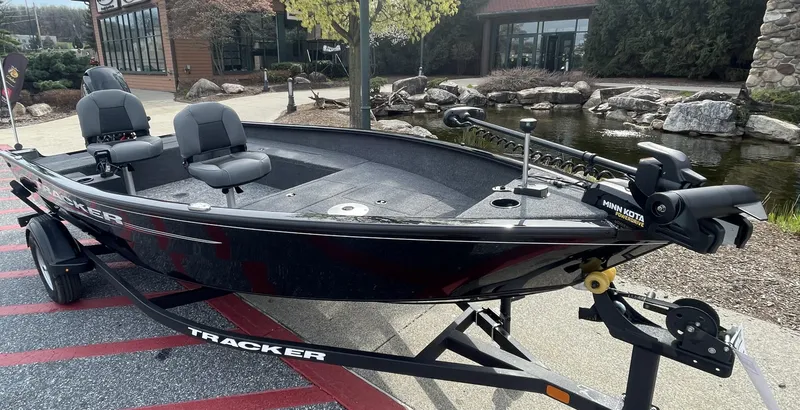 Slide: The Image of 2025 Tracker Super Guide V-16 T fishing boat on trailer, parked outdoors. - 2