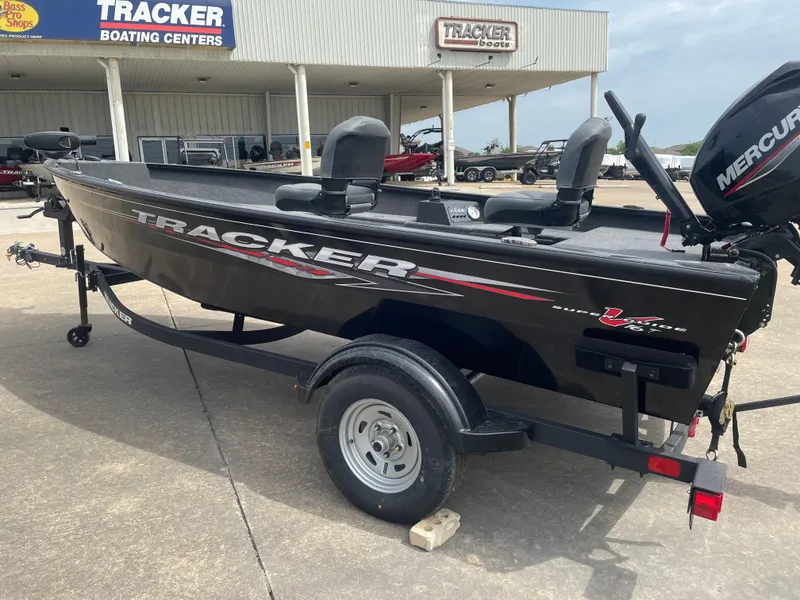 Slide: The Image of 2025 Tracker Super Guide V-16 T boat at dealership, featuring Mercury engine. - 3