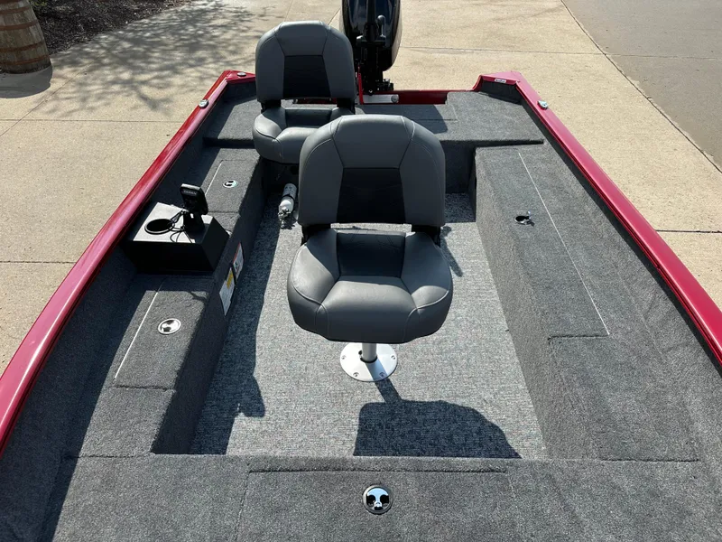 Slide: The Image of 2025 Tracker Super Guide V-16 T boat interior with two seats and carpeted deck. - 5