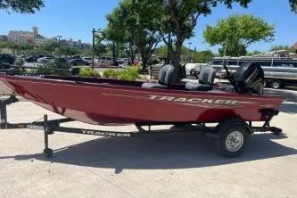 The Image of 2025 Tracker Super Guide V-16 T boat on trailer, parked outdoors. - 0