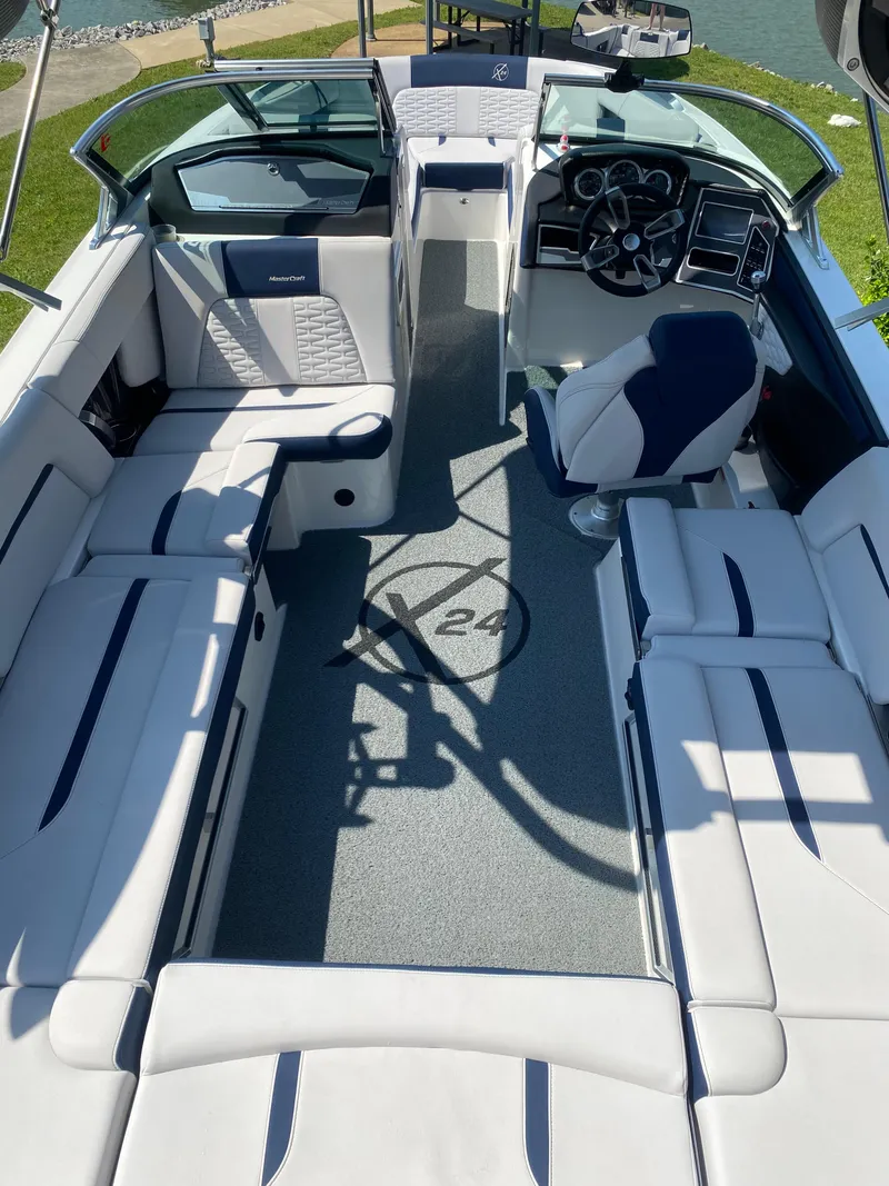 Slide: The Image of 2021 MasterCraft X24 boat interior with luxurious seating and modern dashboard. - 11