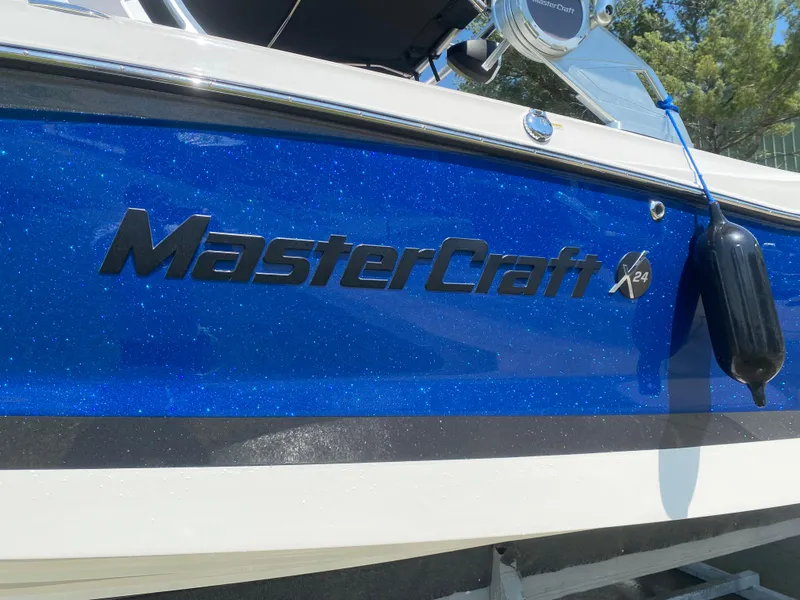 Slide: The Image of 2021 MasterCraft X24 boat with blue exterior and logo. - 3
