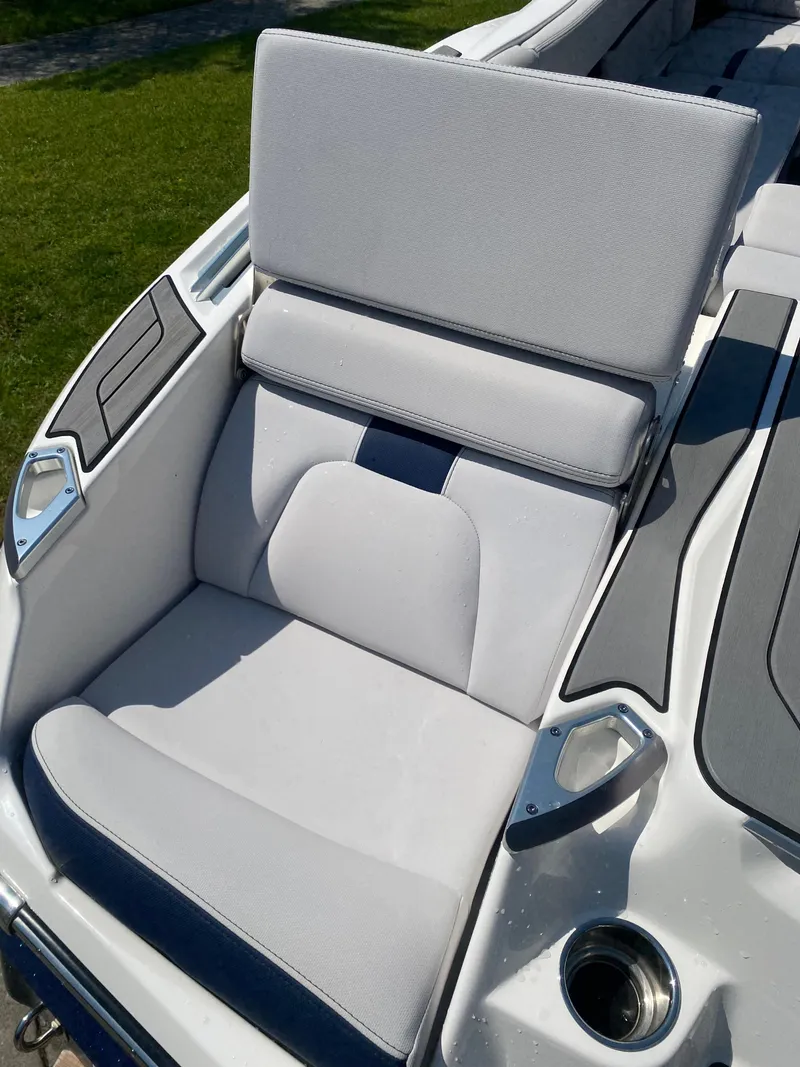 Slide: The Image of 2021 MasterCraft X24 boat seat with gray upholstery and cup holder. - 7