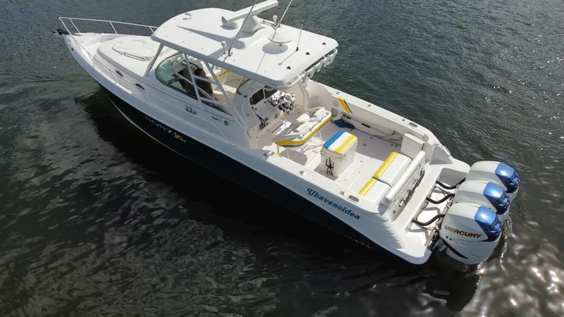 Slide: The Image of 2006 Donzi 38 ZSF boat with triple Mercury engines on calm water. - 13