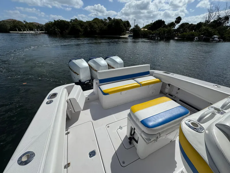 Slide: The Image of 2006 Donzi 38 ZSF boat with triple engines, colorful seating, and scenic water backdrop. - 16