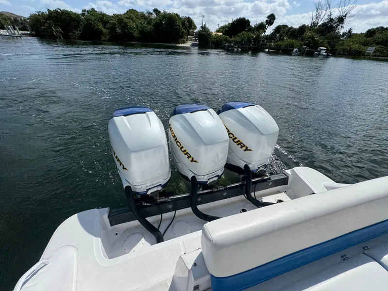 Slide: The Image of 2006 Donzi 38 ZSF boat with triple Mercury outboard engines on a calm waterway. - 17
