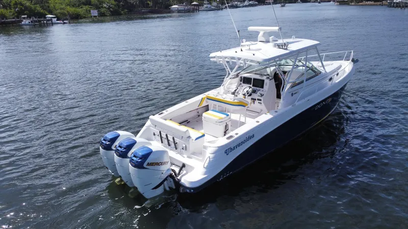 Slide: The Image of 2006 Donzi 38 ZSF boat with triple Mercury engines on a calm waterway. - 2