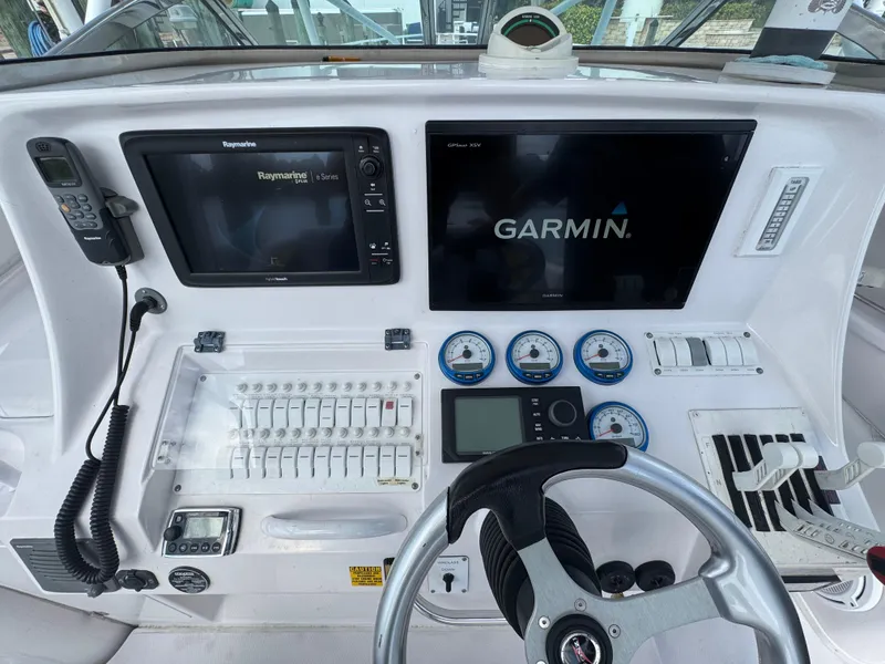 Slide: The Image of Control panel of a 2006 Donzi 38 ZSF boat with Garmin and Raymarine displays. - 20